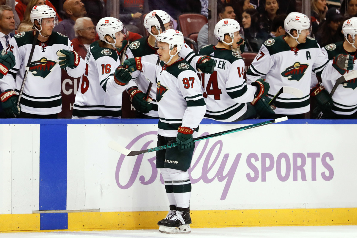 Rem Pitlick of the Minnesota Wild skates with the puck while Dougie News  Photo - Getty Images