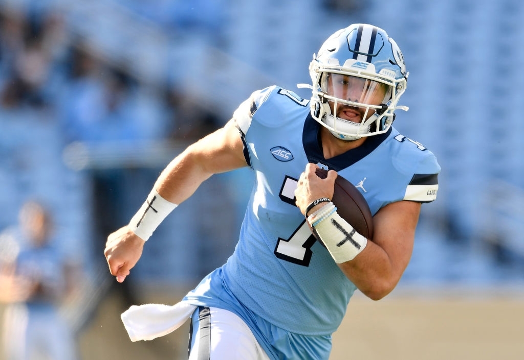 Sam Howell #7 of the North Carolina Tar Heels scrambles against the Wake Forest Demon Deacons during their game at Kenan Stadium on November 14, 2020 in Chapel Hill, North Carolina. The Tar Heels won 59-53.